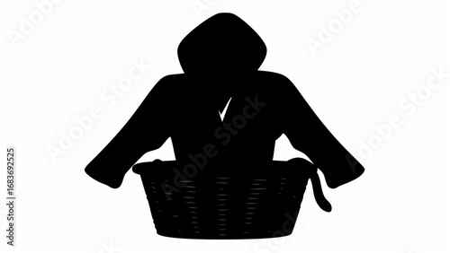 Silhouette of a figure in a hooded cloak sitting inside a woven basket with a handle on the right side