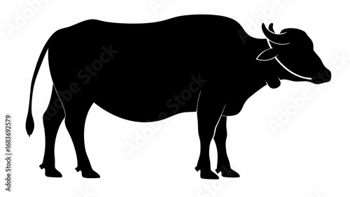 Silhouette of a water buffalo standing in profile with its head turned to the right side view image