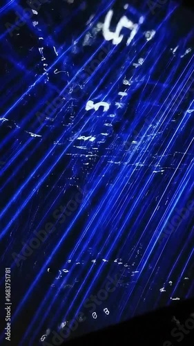 Immersive blue laser light show illuminating dark space
