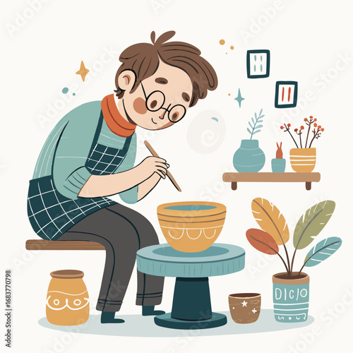Young artist decorating a clay bowl on a potters wheel.