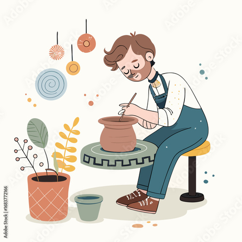 Young man in an apron creating ceramic pottery on a wheel in his workshop.