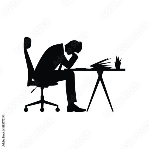 Silhouette of a stressed businessman overwhelmed at his desk