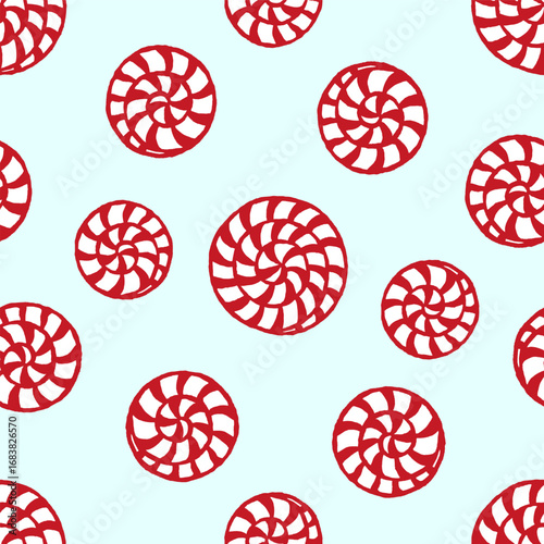 Vector seamless pattern with freehand drawn cartoon christmas striped sugar candies bonbon on light blue background