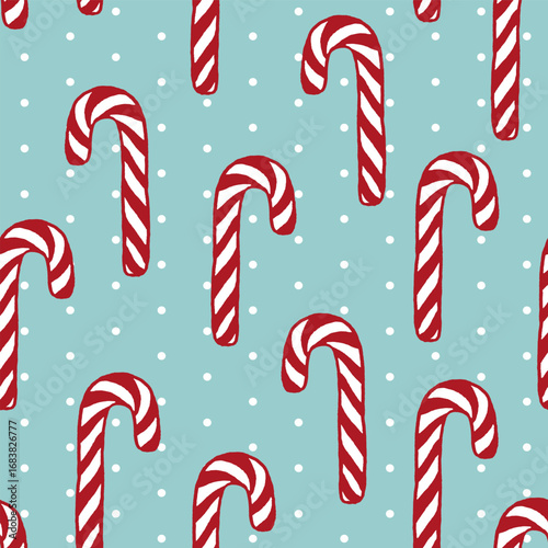 Vector seamless pattern with freehand drawn cartoon sugar candy canes on blue background with polka dots