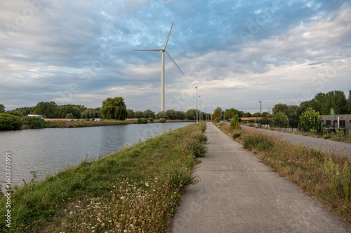 The canal during a colorful sunset with wind mills in Beersel, Flemish brabant Region, Belgium