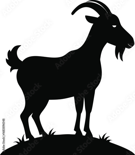 Proud black silhouette of a majestic goat standing firmly on grassy ground with horns silhouette