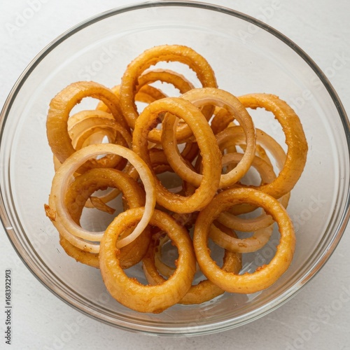 Crispy Golden Brown Fried Onion Rings in Glass Bowl