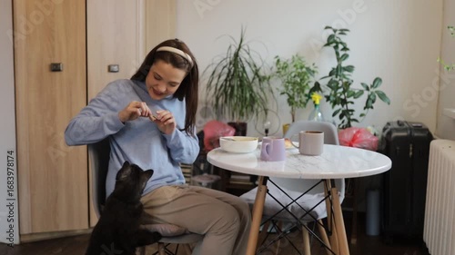 a young woman having breakfast at home at the table
