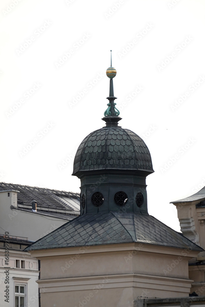 Obraz premium Small architectural dome with ornate spire and circular openings crowns historic building, representing heritage, craftsmanship, and urban tradition