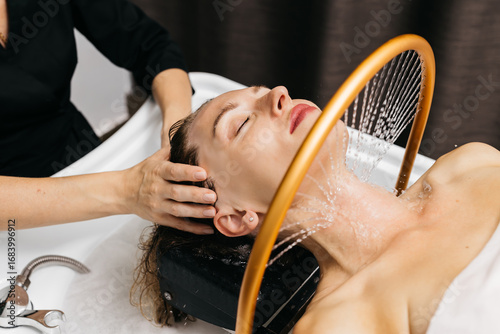 Cuadro en lienzo Woman receiving hydromassage therapy in a serene spa environment, with soothing
