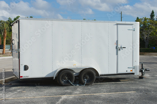 Принти на полотні White Enclosed Cargo Trailer Parked in a Sunny Lot