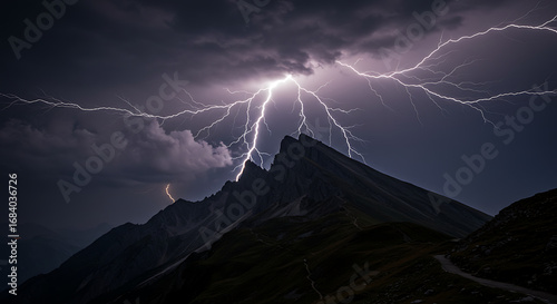The majestic mountain peaks are dramatically illuminated by a vibrant bolt of lightning, showcasing the raw power of nature against a dark, foreboding sky. 