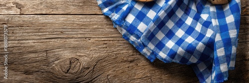 Rustic wooden table with blue and white checkered cloth