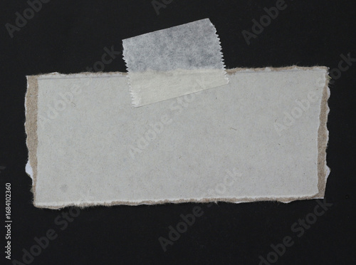 sheet of torn rip paper with masking tape