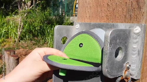 Student unlocking a YONDR lockable mobile phone case pouch..Yondr's pouches are intended to reduce distractions and prevent unauthorized photography or recording