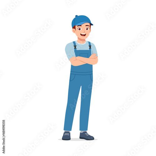 Happy Young Asian Man in Blue Overalls Standing with Arms Crossed and Smiling