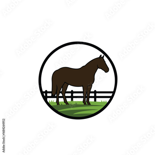 Brown horse standing in a grassy field with a fence