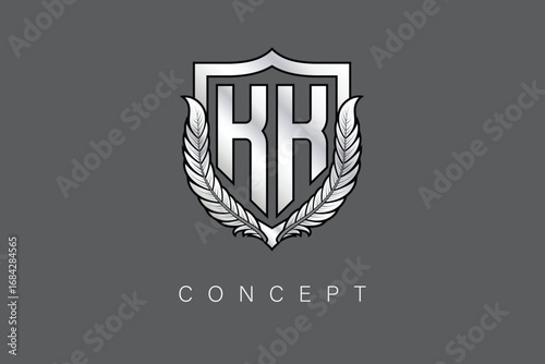 KK Creative Initial Letter Logo with Shield and Laurel Wreath Silver Metallic Branding Emblem on Gray Background.