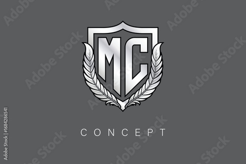 MC Creative Initial Letter Logo with Shield and Laurel Wreath Silver Metallic Branding Emblem on Gray Background.