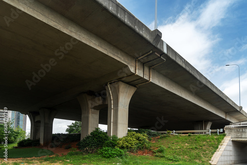 Concrete structure and asphalt road space under the overpass in the city