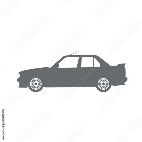 Side profile silhouette of a classic grey sedan car with a rear spoiler and spoked wheels, representing a vintage sports vehicle.