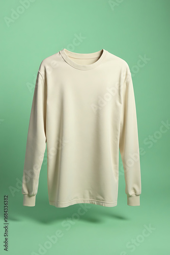 Plain White Crewneck Sweatshirt Hanging in Green Studio Background