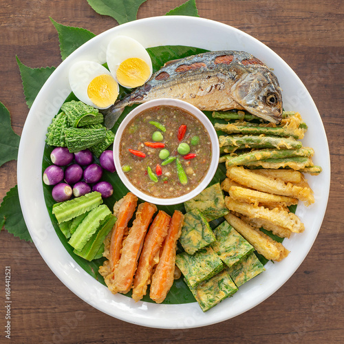 Shrimp paste chili paste with fried mackerel and various vegetables. This chili paste is made from shrimp paste as the main ingredient and has a strong, sour, spicy, salty, and slightly sweet flavor.