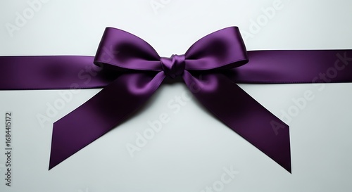 Elegant purple silk ribbon bow against a clean minimalist backdrop