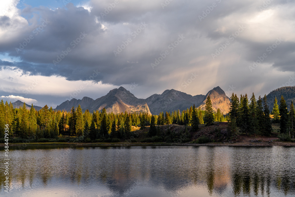 Fototapeta premium Sunset over the mountains by the lake