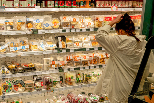 A Shopper's Dilemma: Choosing from a Colorful Array of Prepared Meals and Snacks in a Grocery Store Aisle