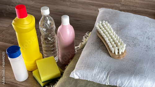 Fotografie Mold on pillows, brush, gloves and chemicals nearby - vinegar, bleach and powder for removing fungus