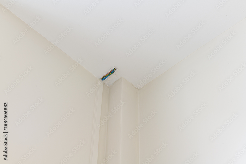 Fototapeta premium Close up detail of motion sensor during house renovation. Modern home construction focuses on clean lines and security for feeling of safety and peace of mind