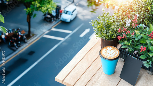 Coffee cup latte art blue cup balcony table plant arrangement morning sunlight cozy city view