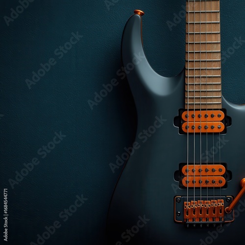 Close up of a dark gray electric guitar with copper colored hardware, set against a dark blue textured background. The image is well lit, highlighting the guitar's details.