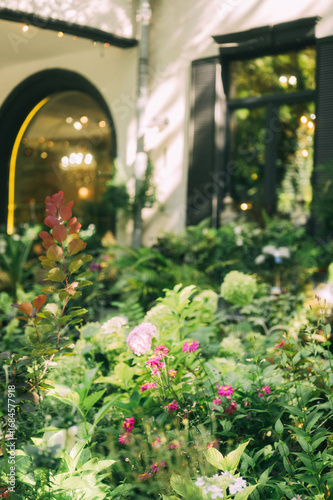 Elegant Floral Shopfront with Lush Greenery and Blooming Flowers