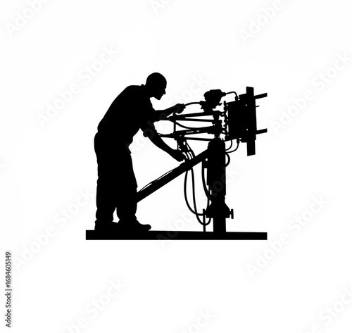 Silhouette of a technician working on a machine spindle
