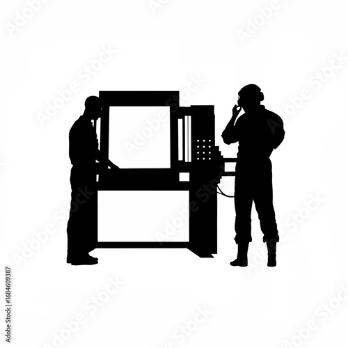 Silhouette of technician operating a cnc lathe machine