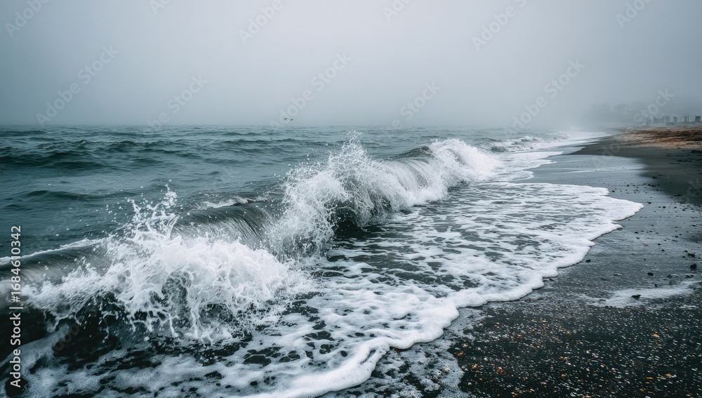 Fototapeta premium Misty ocean waves crashing on a dark sand beach