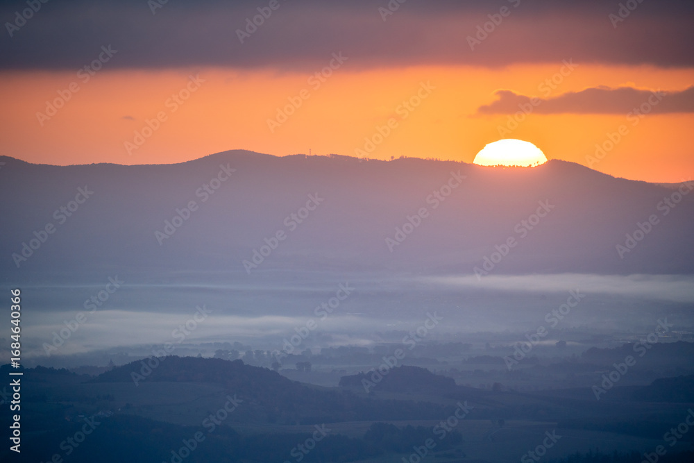 Fototapeta premium Sunrise Over Distant Hills