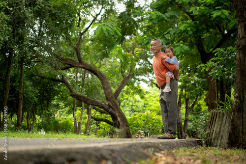 Grandfather and granddaughter jogging together in the park
