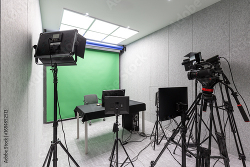 green screen studio with lighting and camera.