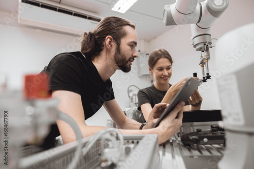 Obraz na płótnie Industrial Robotics program university students learning education mechanical assembly with Robot Universal Training Platform robot arm simulation model in engineering lab classroom