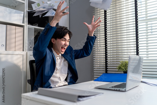 Asian young businessman checking sale order on computer in the office. 