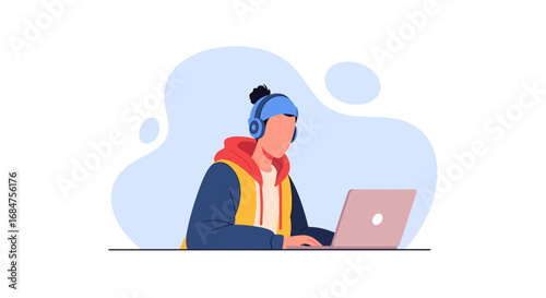 Focused young person wearing headphones and a winter hat, diligently working on a laptop. Ideal for themes of remote education, online learning, or digital nomad lifestyle.
