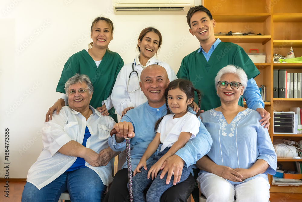 Obraz premium Senior man and women with grandchild feeling happy in home care with friendly caregiver team