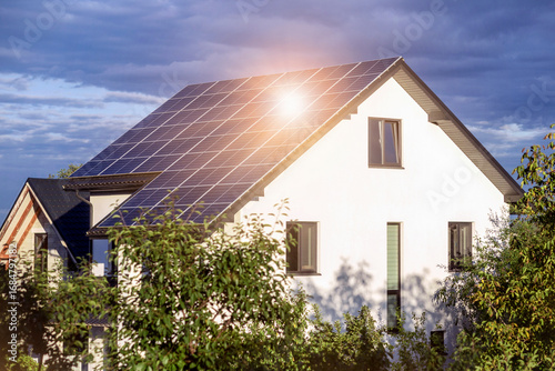 Solar Modern House with Solar Panel Full Roof and Landscape Garden. Sun Energy and Eco Home.