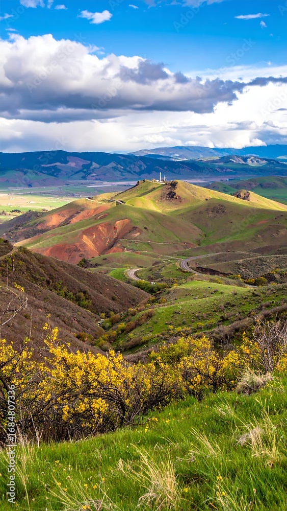 Naklejka premium Mountain vista, winding road, colorful hills, vibrant landscape