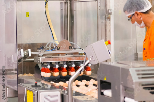 Chicken eggs, on conveyor line at egg packing factory.