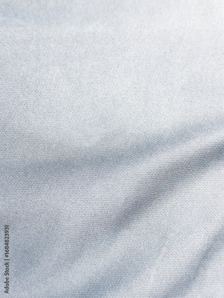 Naklejka premium Abstract Silk Texture: Soft, flowing silk creates a mesmerizing display of light and shadow, capturing a sense of luxury and tranquility.