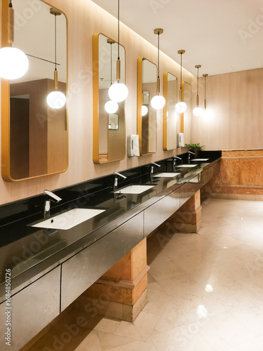 фотографія Sleek public restroom with illuminated mirrors creating a modern and elegant atmosphere